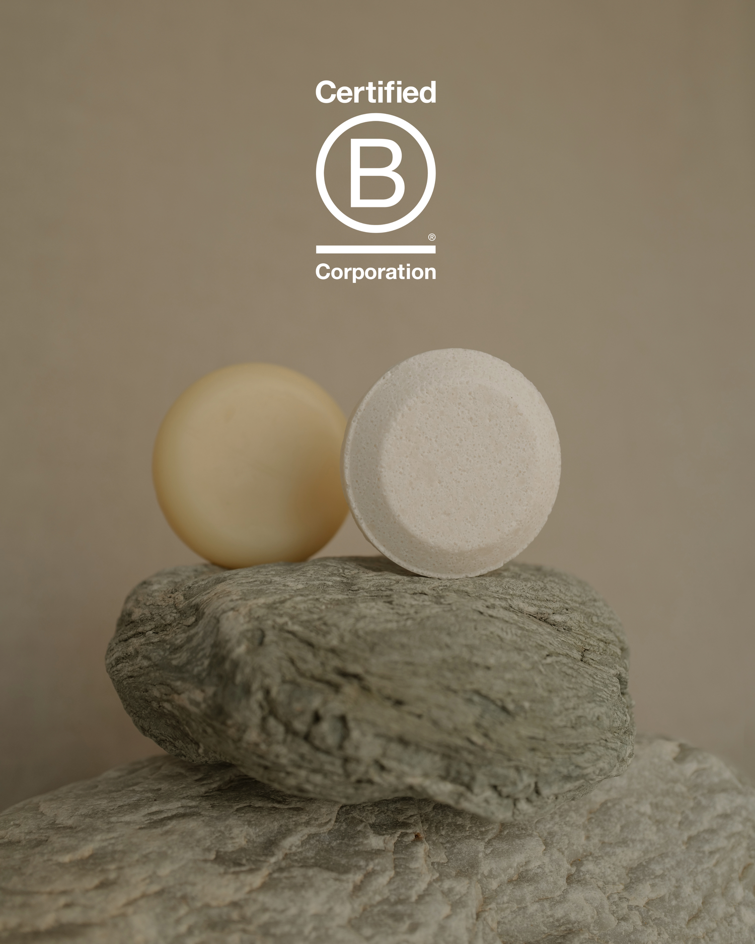 Two solid shampoo bars on stone surface with neutral background, Laguna Cyprien sustainable haircare, natural ingredients, eco-friendly beauty.